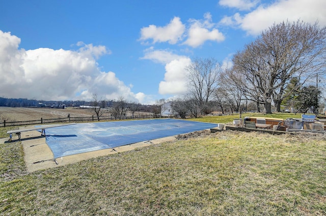 view of pool with a lawn