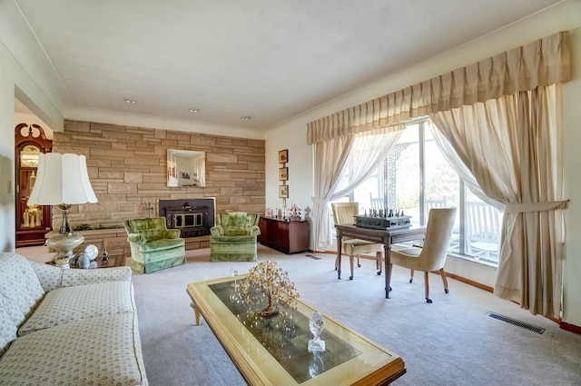 living room with visible vents, light carpet, a healthy amount of sunlight, and a wood stove