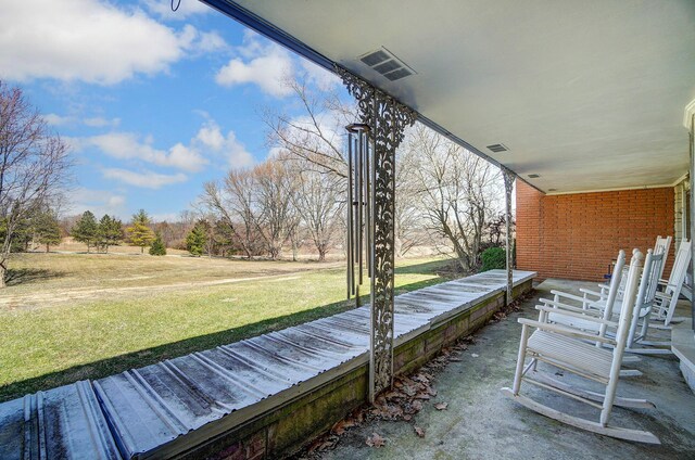 deck featuring visible vents and a yard