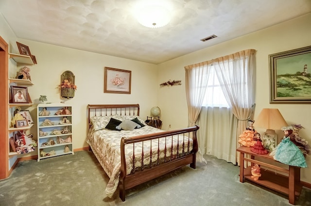 carpeted bedroom featuring visible vents