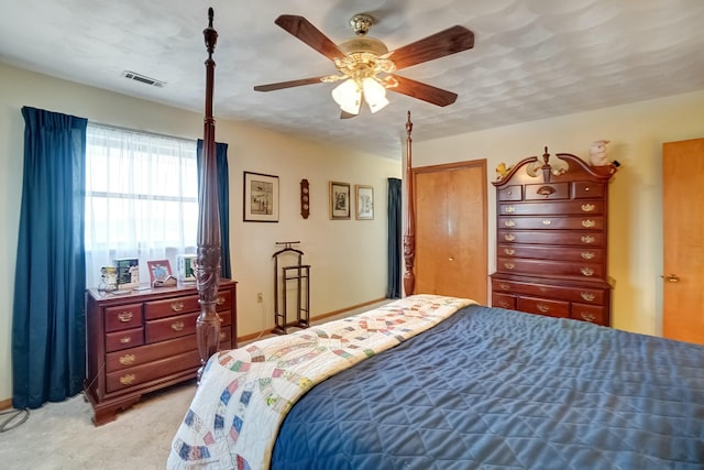 bedroom with light carpet, visible vents, a closet, and ceiling fan