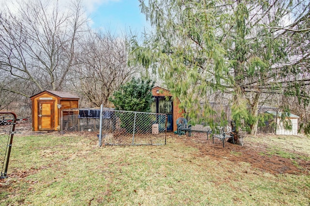 view of yard with an outdoor structure, fence, and a shed