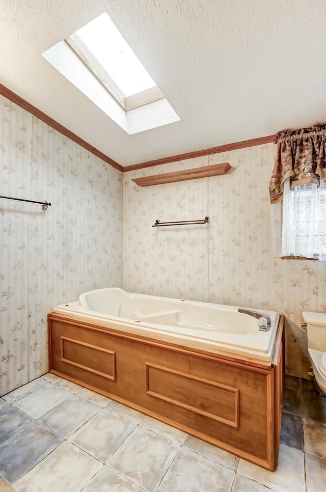 bathroom featuring tile patterned flooring, wallpapered walls, toilet, vaulted ceiling, and a bath