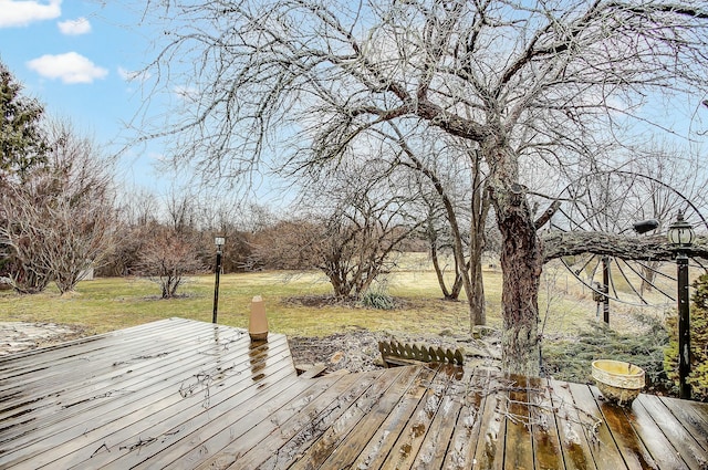 wooden deck featuring a yard