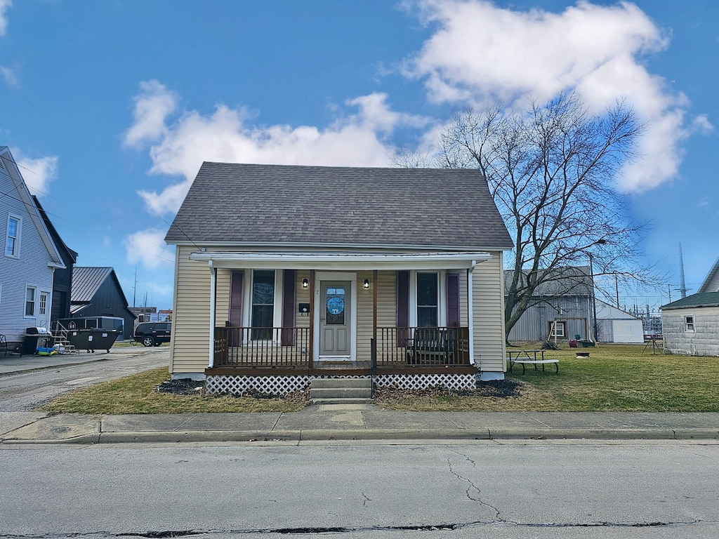 bungalow-style house featuring a front lawn and covered porch