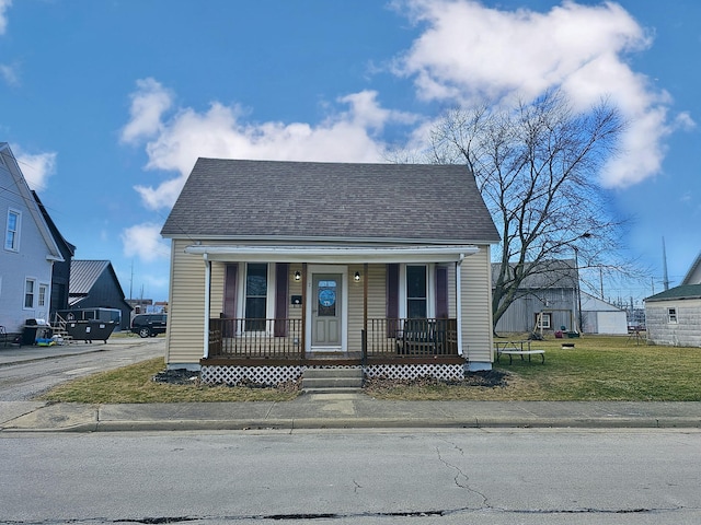 bungalow-style house featuring a front lawn and covered porch