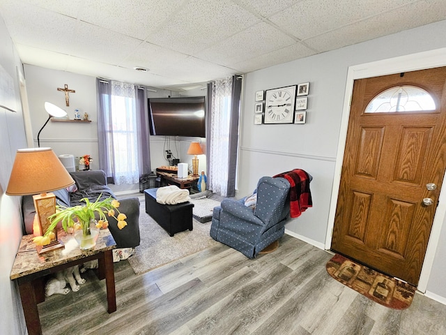 entryway with wood-type flooring and a paneled ceiling