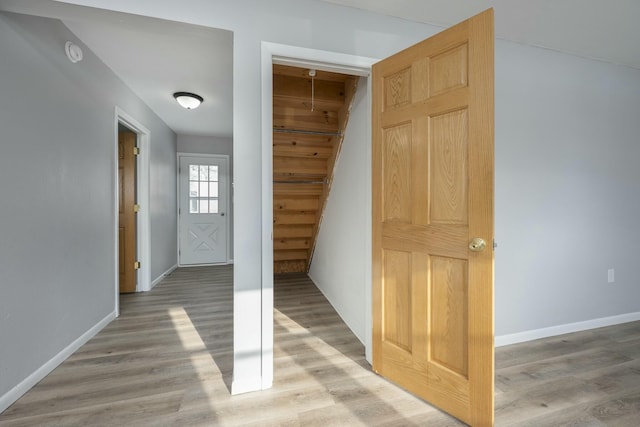 interior space featuring baseboards and wood finished floors