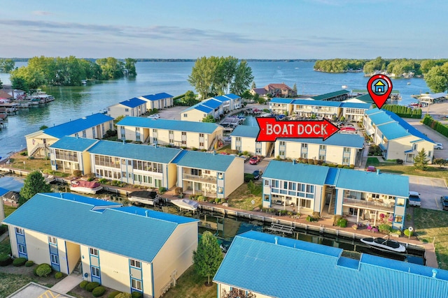 drone / aerial view featuring a residential view and a water view