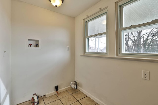 clothes washing area featuring laundry area, baseboards, light tile patterned floors, and washer hookup