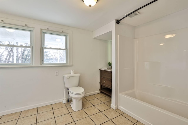 bathroom with tile patterned flooring, toilet, vanity, baseboards, and shower / bathing tub combination