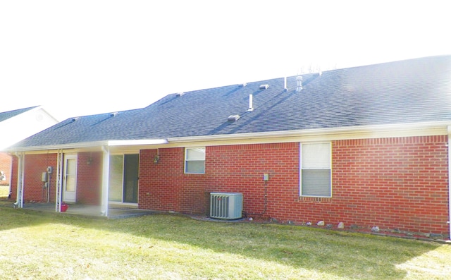 back of house featuring a yard, central AC unit, and a patio