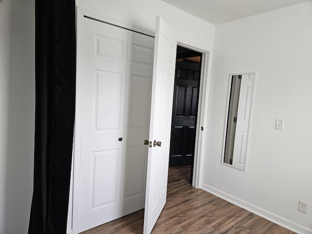 corridor with dark hardwood / wood-style floors