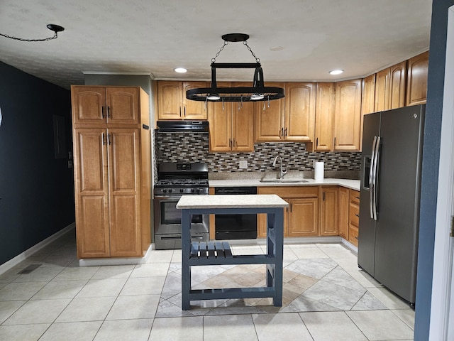 kitchen featuring sink, backsplash, light tile patterned floors, and appliances with stainless steel finishes