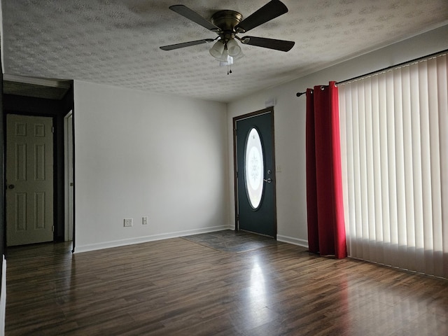 entrance foyer featuring dark hardwood / wood-style flooring, ceiling fan, and a textured ceiling