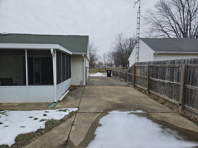 view of snow covered exterior featuring a sunroom