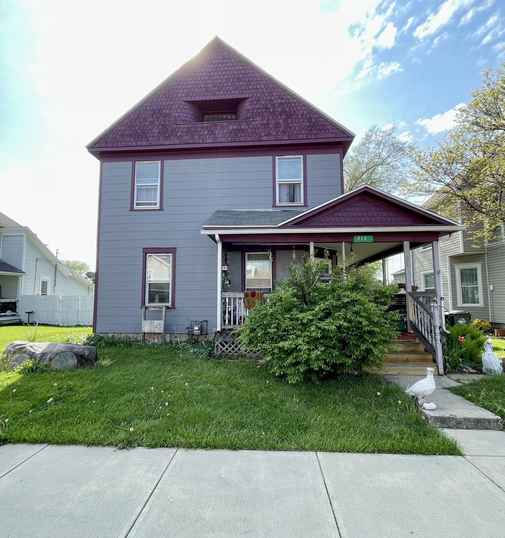 712 S Clay St, Troy, OH 45373 - view of property with a porch and a front yard