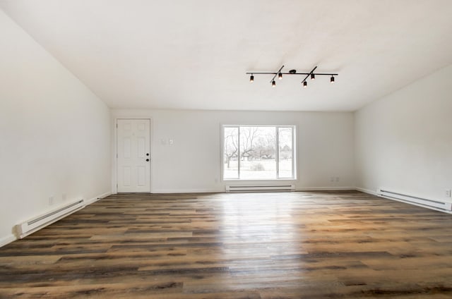 unfurnished room with dark wood-type flooring, a baseboard radiator, and baseboards