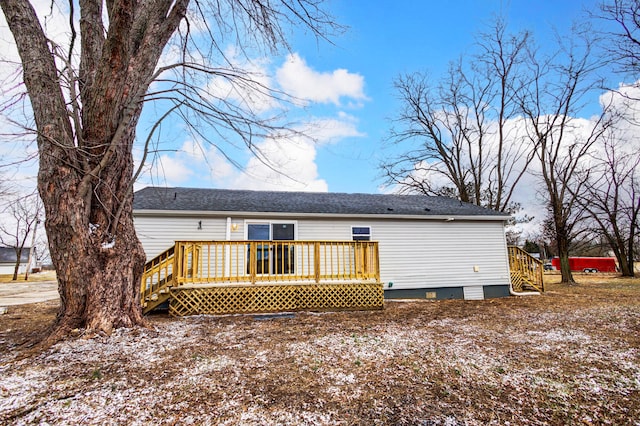 back of house with crawl space and a deck