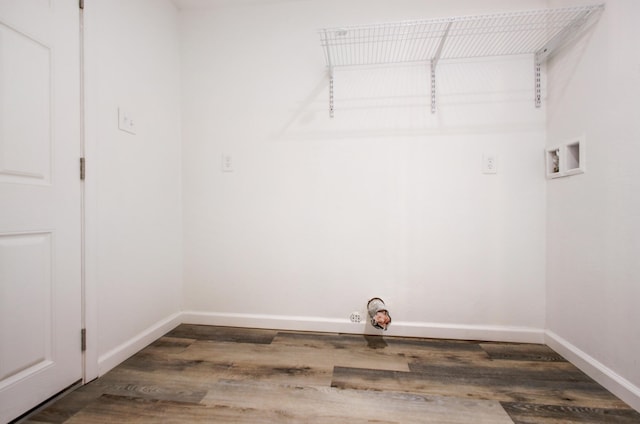 clothes washing area with laundry area, hookup for a washing machine, baseboards, and wood finished floors