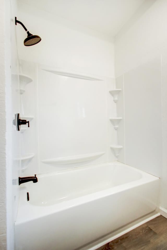 bathroom with a shower, a tub to relax in, and wood finished floors