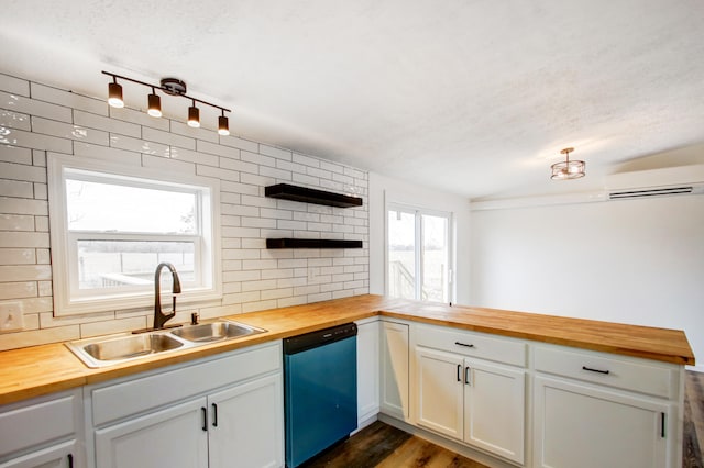 kitchen featuring dishwashing machine, butcher block counters, a sink, and a wall mounted air conditioner