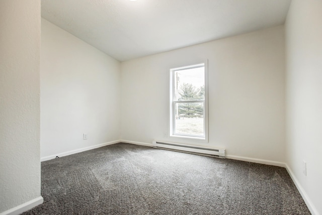 carpeted spare room featuring a baseboard radiator and baseboards