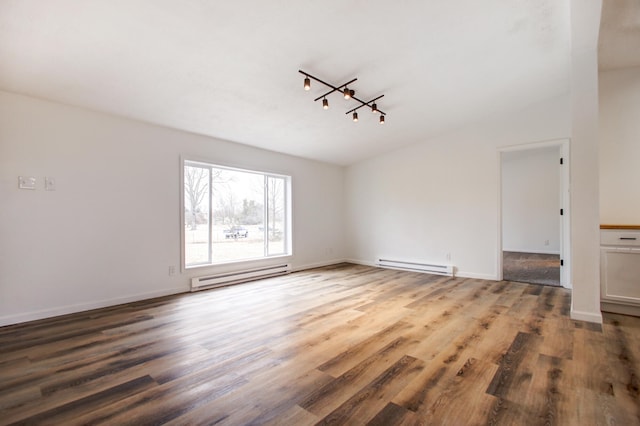 unfurnished room with baseboard heating, wood finished floors, rail lighting, and baseboards