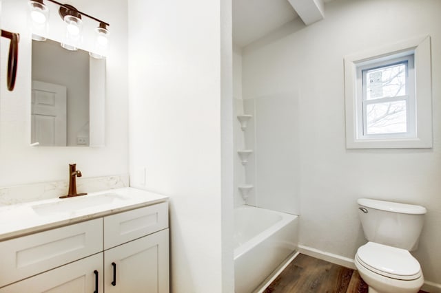 full bath with toilet, baseboards, wood finished floors, and vanity