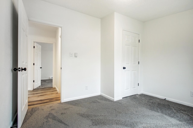 unfurnished bedroom featuring carpet flooring and baseboards