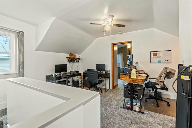 home office featuring baseboards, ceiling fan, and vaulted ceiling