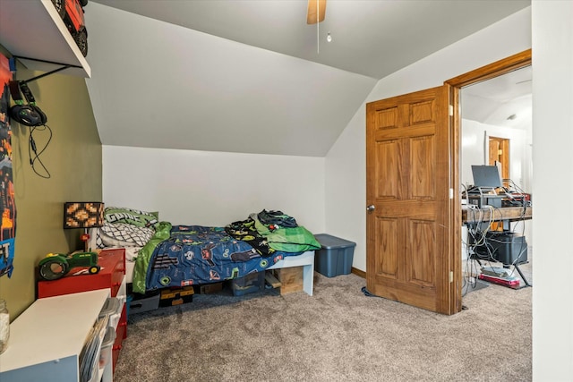 bedroom with ceiling fan, lofted ceiling, and carpet floors