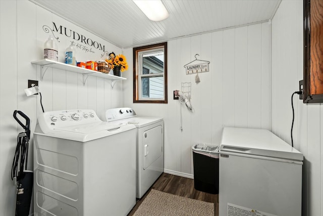 laundry area with washer and dryer, laundry area, and dark wood-type flooring