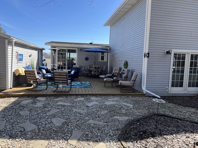 rear view of house featuring a wooden deck