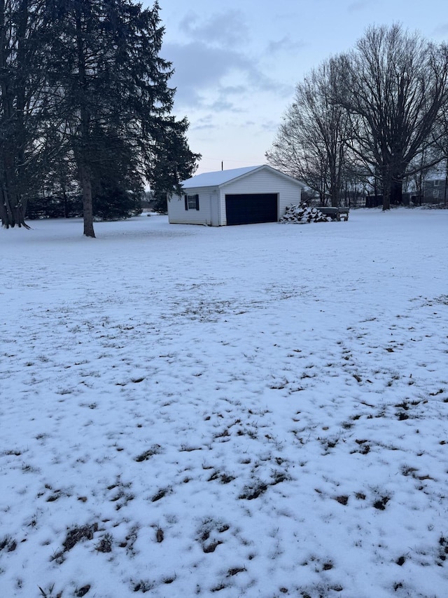 yard layered in snow featuring an outbuilding