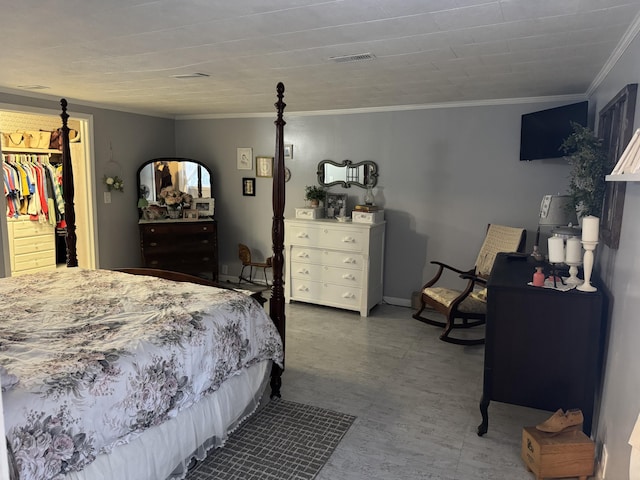 bedroom with tile patterned floors, a spacious closet, visible vents, and ornamental molding