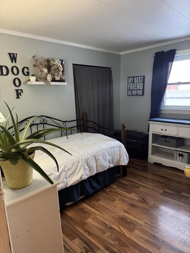 bedroom featuring crown molding and wood finished floors