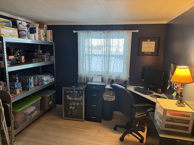 home office with ornamental molding and light wood finished floors