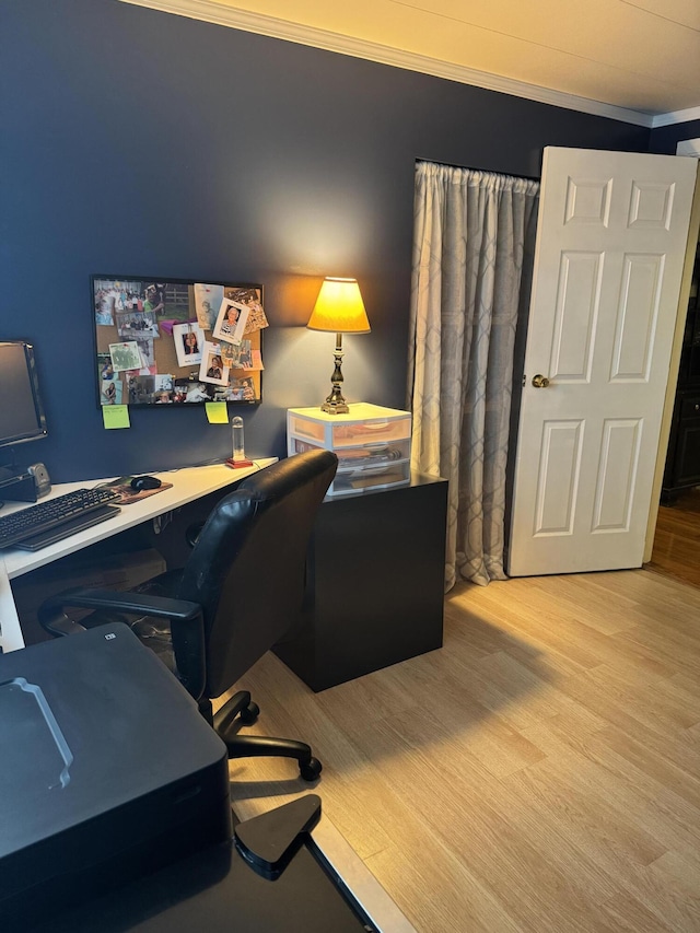 office area with ornamental molding and wood finished floors