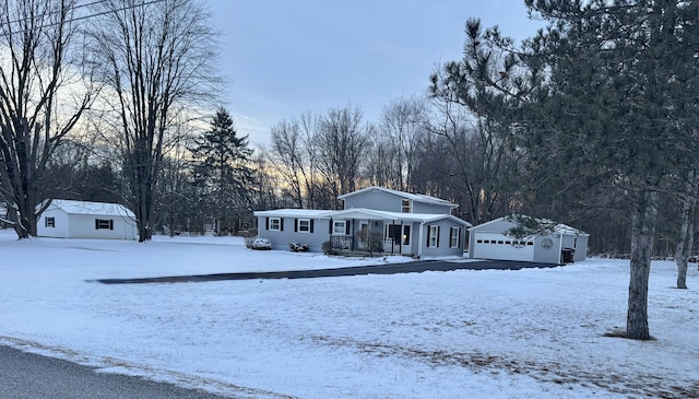 manufactured / mobile home with an outdoor structure and a detached garage