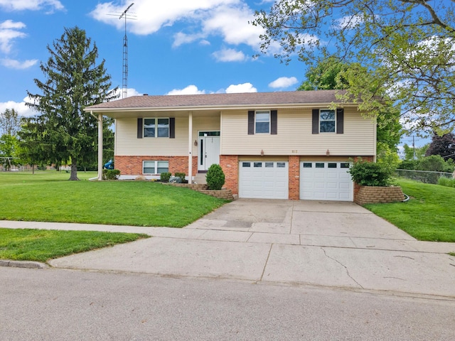 817 Dartmouth Rd, Troy, OH 45373 - bi-level home featuring an attached garage, driveway, and brick siding
