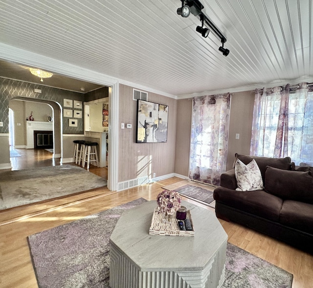 living room featuring wood-type flooring, wooden ceiling, and track lighting