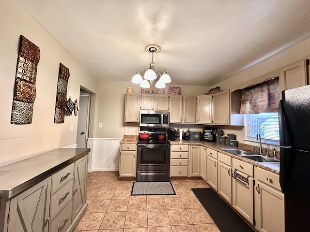 kitchen featuring black fridge, cream cabinets, sink, and electric range oven