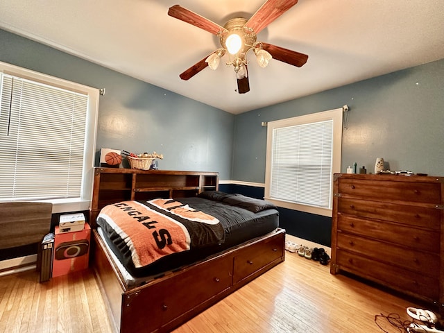 bedroom with ceiling fan and light hardwood / wood-style floors