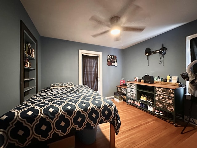 bedroom with wood-type flooring and ceiling fan