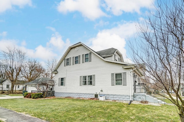 view of home's exterior with a yard