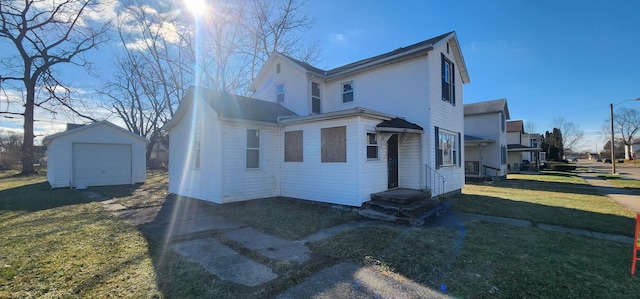 view of front of house featuring a garage, an outdoor structure, and a front yard