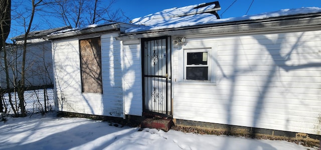 view of snow covered property entrance