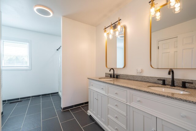 4100 Joshane St, Springfield, OH 45502 - full bathroom with baseboards, tile patterned floors, a sink, and double vanity