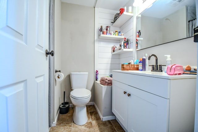 bathroom with visible vents, vanity, toilet, and baseboards